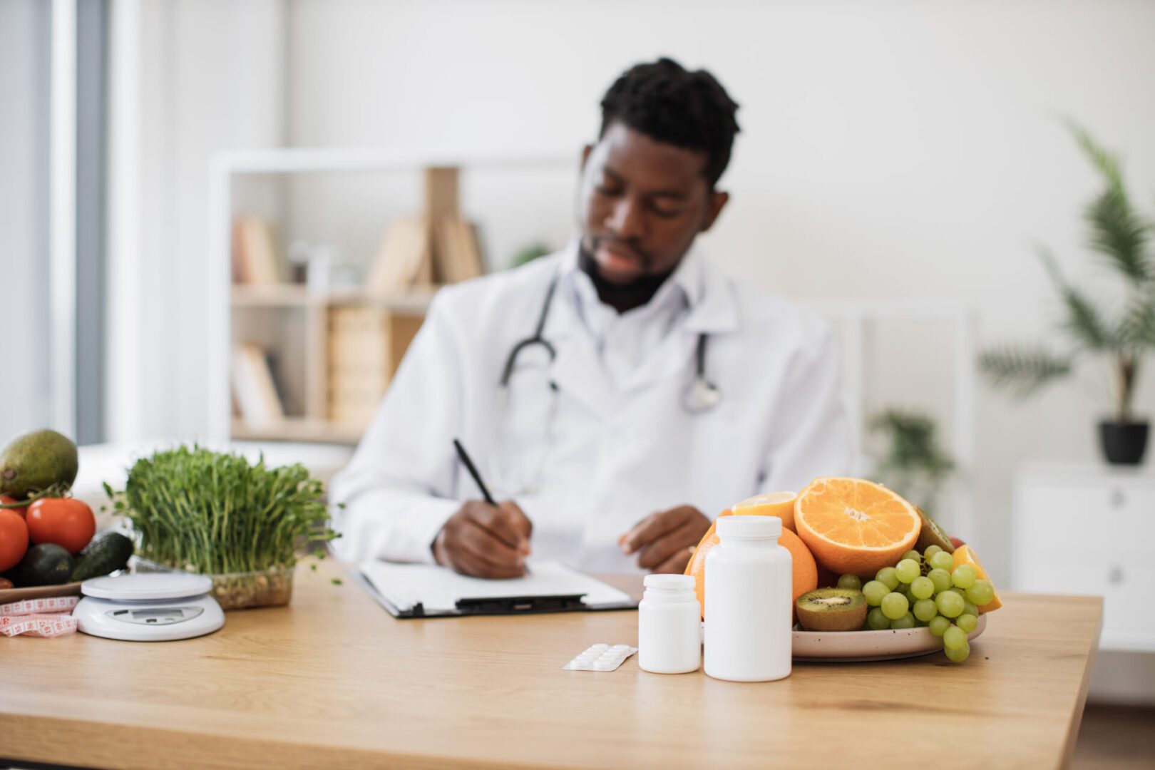 Fruits and pills bottles being kept on desk at doctor's